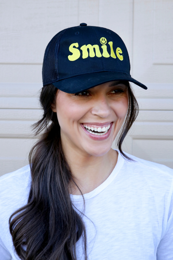 smile trucker hat in black and yellow