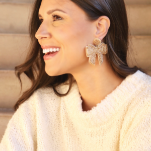 topped with a bow gold beaded earrings